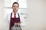 Portrait of waiter holding wine glasses