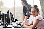 Portrait confident girl student using computer in library