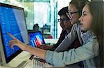 Students programming at computer in computer lab classroom