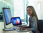 Portrait smiling, confident girl student programming at computer in classroom