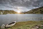 Canoe by lake at sunset, San Bernardino, Ticino, Switzerland, Europe