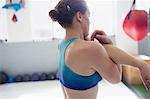 Woman stretching arm and shoulder in gym