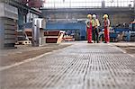 Male  workers talking in factory