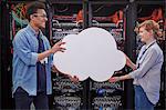 IT technicians holding cloud in server room, cloud computing
