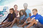 Portrait smiling multi-ethnic family on sunny summer beach