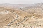 Aerial view of country road winding through the Jordanian desert wilderness, Jordan.