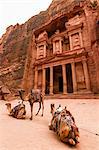 Exterior view of the rock-cut architecture of Al Khazneh or The Treasury at Petra, Jordan, camels in the foreground.