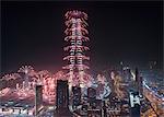 Cityscape of Dubai, United Arab Emirates at night, with fireworks and illuminated skyscrapers.