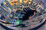 Aerial fish-eye view of Dubai, United Arab Emirates at night, with illuminated skyscrapers and marina.