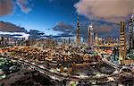 Cityscape of Dubai, United Arab Emirates, with skyscrapers under a cloudy sky.