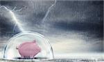 Piggybank safely inside a sphere during a storm . Protect gains from the crisis