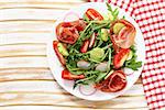 Salad with parma ham, arugula and tomatoes