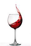 Glass with a splash of red wine isolated on white background. Clarity wineglass and wine. Aesthetics and delight. Relaxation. Luxury.