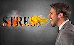 Businessman burns the word stress. stressed business life concept