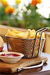 Traditional french fries with ketchup on a wooden table