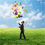 Creative businessman holding a creative colorful balloons