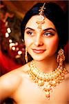 beauty sweet real indian girl in sari smiling on black background, jewelry shining