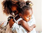 adorable sweet young afro-american mother with cute little daughter, hanging at home, having fun playing smiling, lifestyle people concept, happy smiling modern family close up