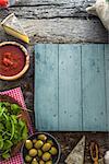 Wooden planks with food. Olives, basil, tomatoes and ingredients on wood