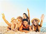 Group of friends having fun on the sunny beach
