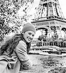 Autumn getaways in Paris. Portrait of smiling young tourist woman on embankment in Paris, France