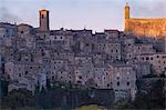 Light of sunrise illuminates the village of Sorano. Sorano, Grosseto province, Tuscany, Italy, Europe