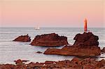 The Jument lighthouse at sunrise, off the island of Ouessant, France.