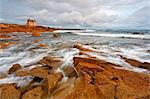 Turpault castle, Morbihan, Brittany, France. The wild coast of Quiberon peninsula and Turpault chateau in a cloudy day