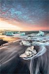 Jokulsarlon glacier lagoon, East Iceland. Blocks of ice on the black beach at sunrise