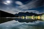 Clouds illuminated by the moon are reflected in Lake Misurina. Cortina d'Ampezzo. Dolomites. Veneto. Italy. Europe