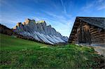 The early morning light illuminates Malga Zannes and the Odle in background. Funes Valley South Tyrol Dolomites Italy Europe