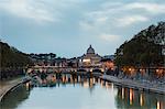 Dusk lights on Tiber River with bridge Umberto I and Basilica di San Pietro in the background Rome Lazio Italy Europe