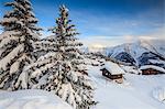 Sunset frames the mountain huts and woods covered with snow Bettmeralp district of Raron canton of Valais Switzerland Europe