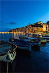 View of blue sea and boats surrounding the colorful village at dusk Portovenere province of La Spezia Liguria Italy Europe