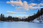 The pink clouds frame the frozen Lago Azzurro at dawn Spluga Valley Province of Sondrio Valtellina Lombardy Italy Europe