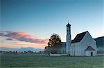 Pink clouds at sunrise on St Coloman Church surrounded by woods Schwangau Bavaria Germany Europe