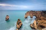 Rocky cliffs framed by turquoise water of the ocean Praia da Marinha Caramujeira Lagoa Municipality Algarve Portugal Europe