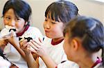 Japanese elementary school kids eating in the classroom