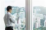 Businesswoman looking out of window