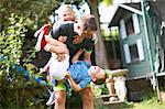 Family playfighting in garden