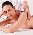 Woman in spa environment, having salt crystal massage