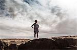 Woman standing on rocks, looking at view, Santa Cruz de Tenerife, Canary Islands, Spain, Europe