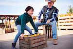 Farmer and grandson at pumpkin farm