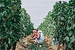 Woman with baby daughter in vineyard, Bergerac, Aquitaine, France