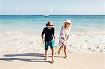 Mother and son walking on beach