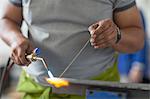 Cropped view of man welding in bodywork repair shop