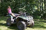 Young girl sitting on quad bike