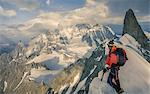 Mountain climber on the Rochefort Ridge looking at Mont Blanc, Courmayeur, Aosta Valley, Italy, Europe