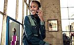 A young woman in a loft apartment making a call.