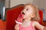 Little girl eating popsicle